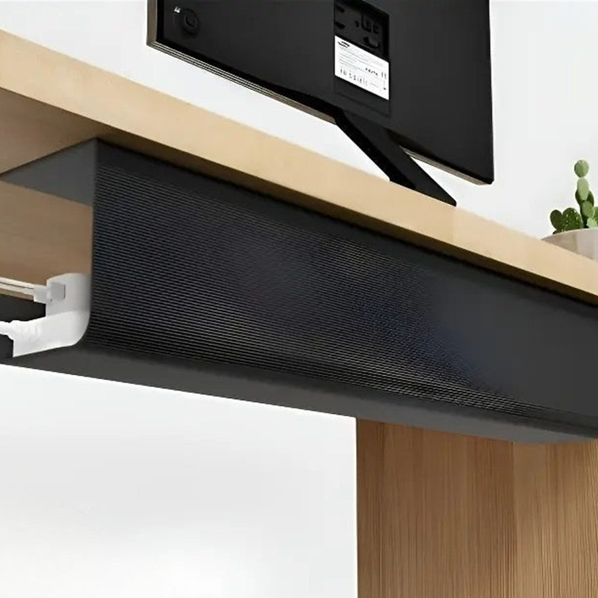 Black under-desk cable tray mounted under a desk